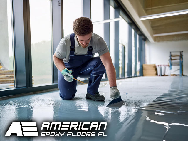 professional technician working inside office pouring beautiful epoxy flooring